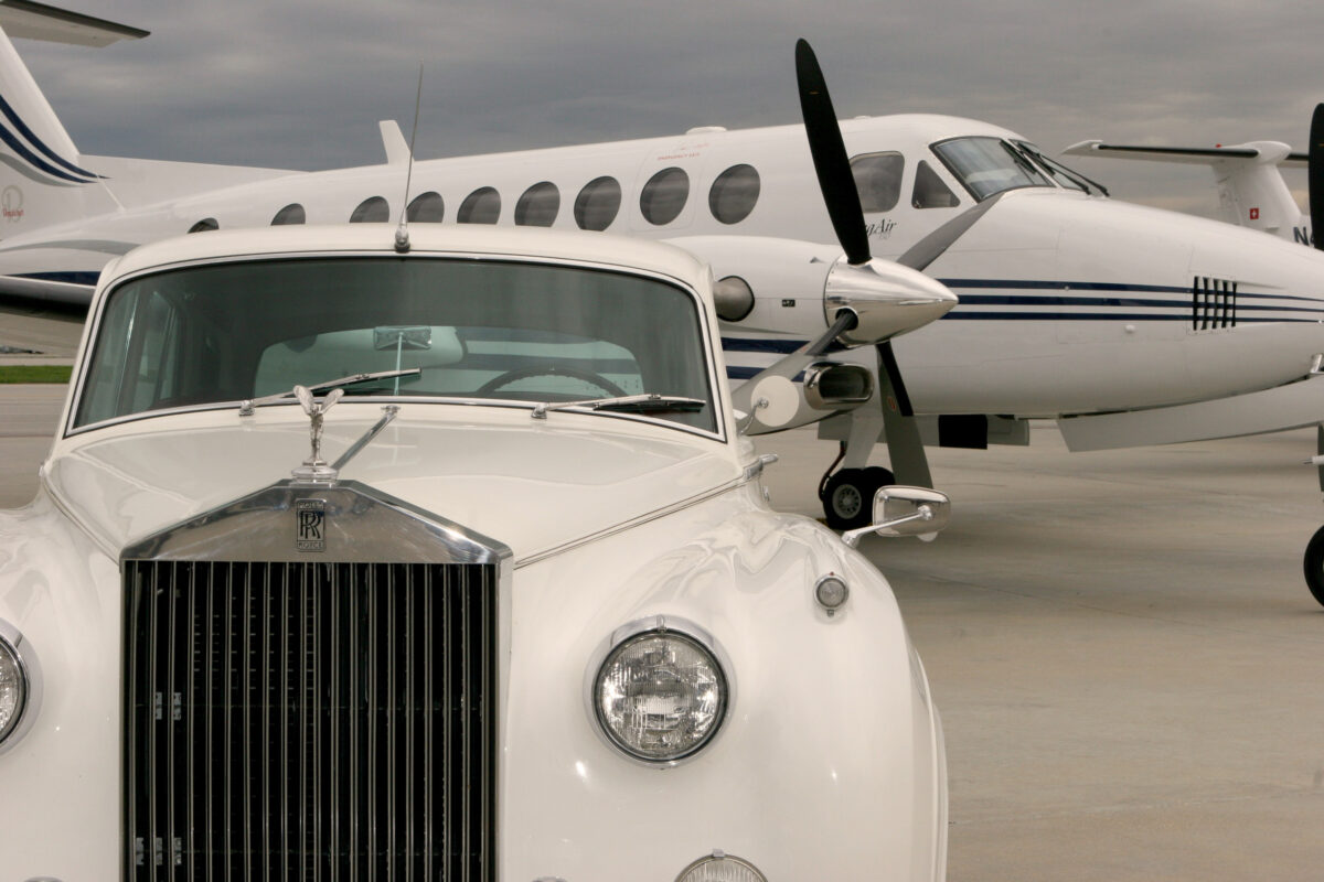 Rolls-Royce chauffeur limousine in front of private plane